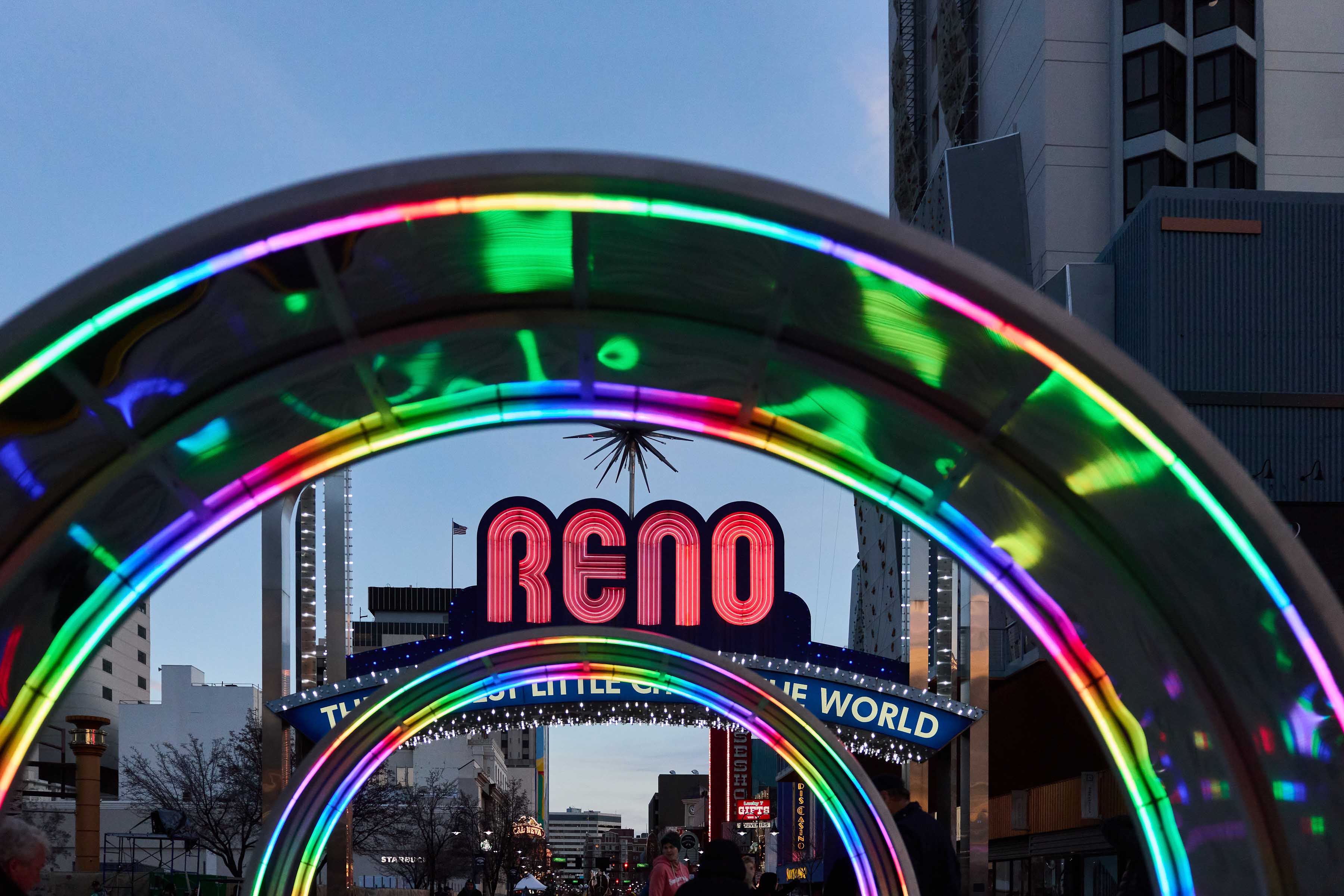 glowing arch shaped sculptures with the view of the Reno arch in the background
