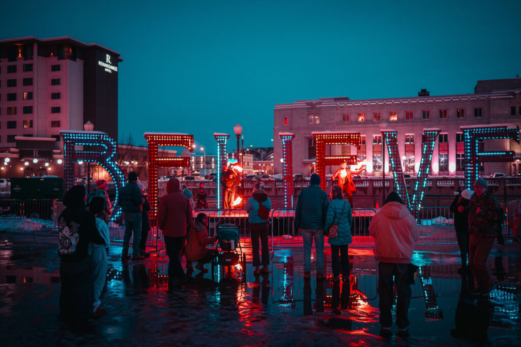 People in front of a sign at western lights