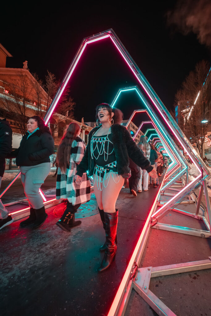 Woman walking through a light path on western lights festival